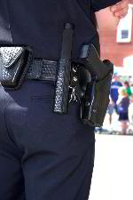 Image of security guard with firearm, baton, cuffs
